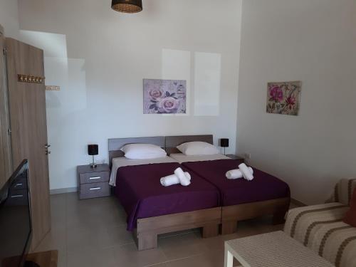 a bedroom with a bed with two pillows on it at ZORBAS Sea View No 5 in Larnaka