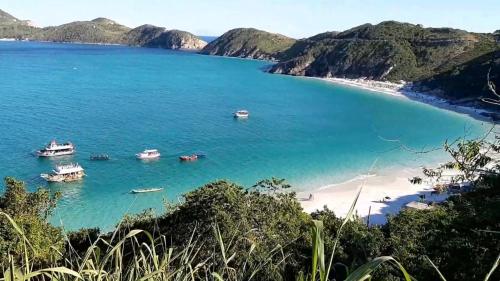 a view of a beach with boats in the water at Casa Arraial do Cabo Beachfront in Arraial do Cabo