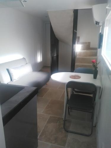 Cette petite chambre comprend une petite table et un lit. dans l'établissement Duplex meublé sortie orange centre, à Orange