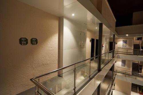 an empty hallway with a clock on a wall at Aureole Mrida - A Boutique Hotel in Lonavala