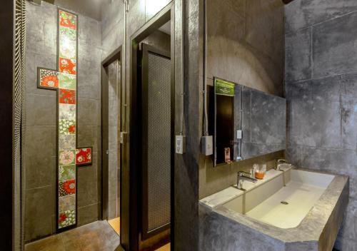 a bathroom with a sink and a mirror at Phuketa - SHA Extra Plus in Phuket