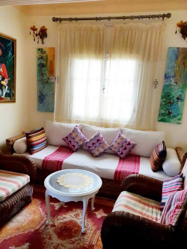 a living room with a couch and a table at Dar Khadija in Asilah