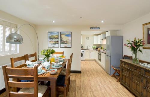 a kitchen and dining room with a table and chairs at Rose Cottage, Filey in Filey