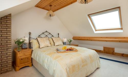 a bedroom with a bed with a tray of fruit on it at Seawinds in Robin Hood's Bay