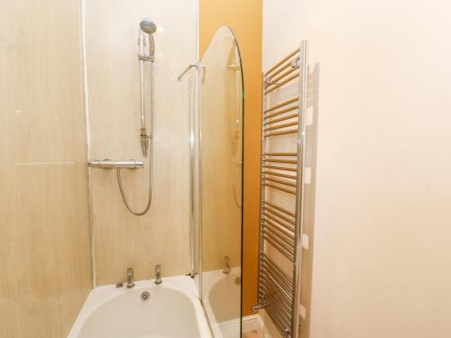 a bathroom with a shower and a white tub at Bowes Barn in Gateshead