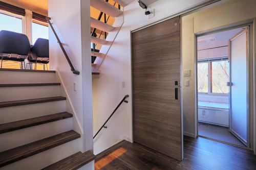 a pivot door in a home with a stairwell at SILVER SPRAY MtFuji view Yamanakako in Yamanakako