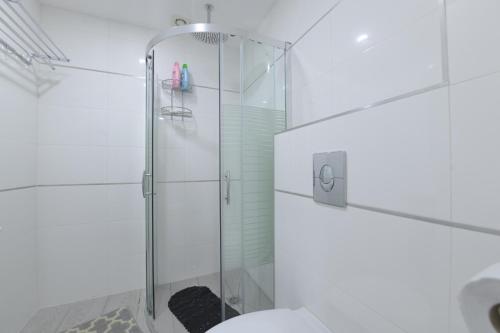 a white bathroom with a glass shower stall at Family holidays in Eilat. in Eilat