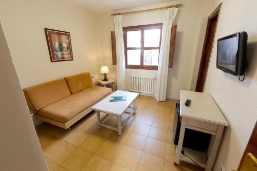 a living room with a couch and a table at Villa Turística de Cazorla in Cazorla