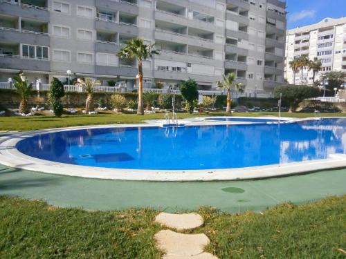 a large blue swimming pool in front of a building at Apartment Agua Viva by Interhome in Cala de Finestrat