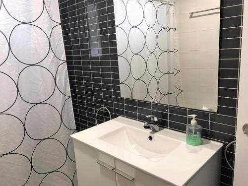 a bathroom with a sink and a mirror at AME137 in Les tres Cales
