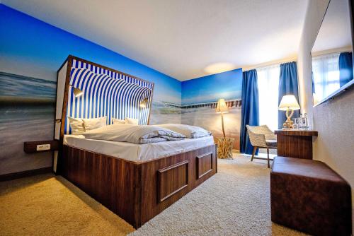 a bedroom with a large bed with blue walls at Dorint Hotel Alzey/Worms in Alzey