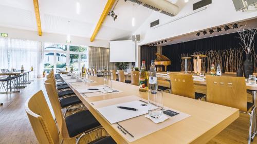 a large dining room with tables and chairs at Dorint Parkhotel Siegen in Siegen