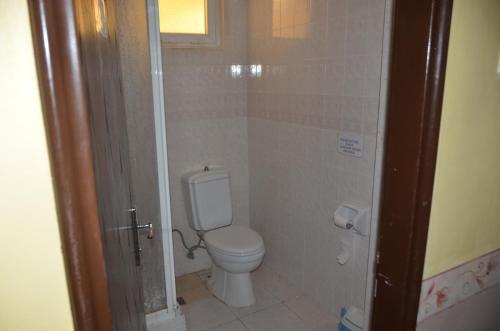 a small bathroom with a toilet and a window at Club Sunset Apartments in Marmaris