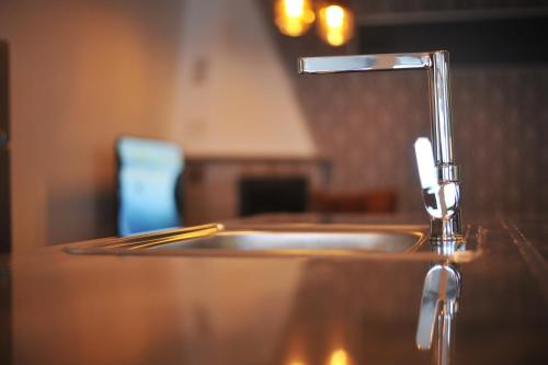 a bathroom sink with a faucet on a counter at Lagadin Lakeview Apartment in Ohrid