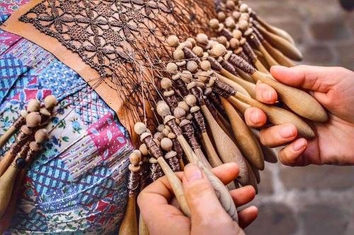 a woman is holding a bunch of objects at Residence Borgo Offida in Offida