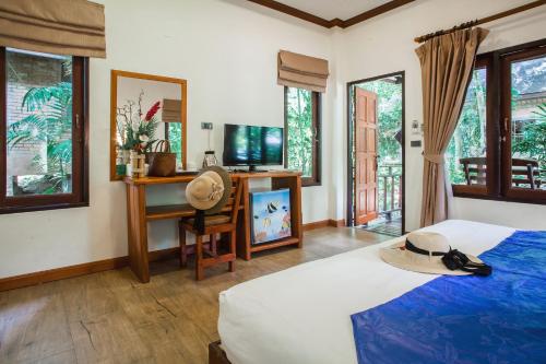 a bedroom with a bed with a hat on it at The Vatika Resort and Spa in Ao Nang Beach