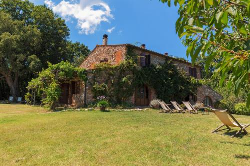 a house with a lawn chair in front of it at La Cerreta - Terme di Sassetta in Sassetta
