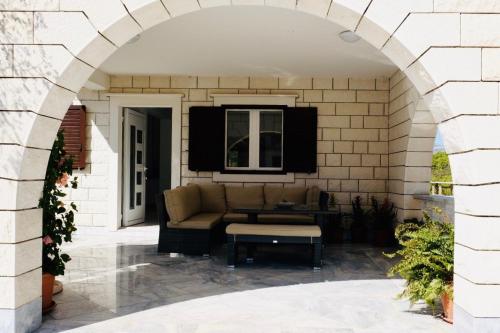 an archway leading to a patio with a couch at Villa Tonika in Povlja