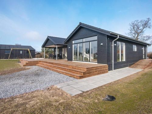 a home with a deck and a house at 12 person holiday home in Haderslev in Haderslev