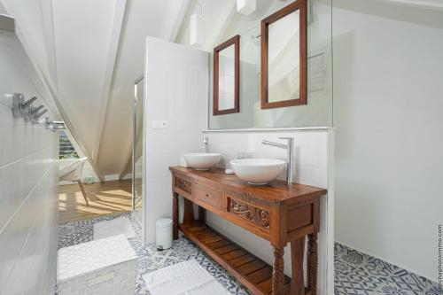 a bathroom with two sinks on a wooden table at CAZA TURQUOIZ in Rivière-Salée