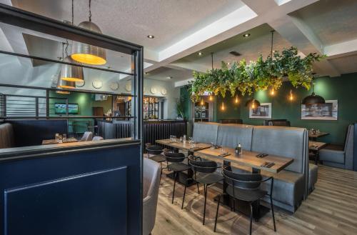 a restaurant with a table and chairs and a bar at Newmachar Hotel in Newmacher