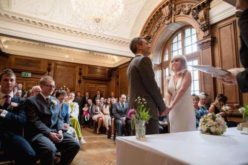 a bride and groom standing next to each other at a wedding at St Giles House in Norwich