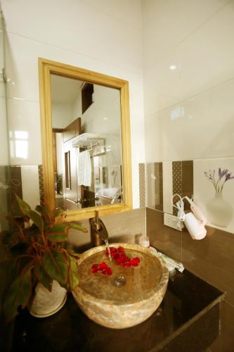 a bathroom with a sink and a mirror at Tan Doan An Bang center beach villas in An Bang
