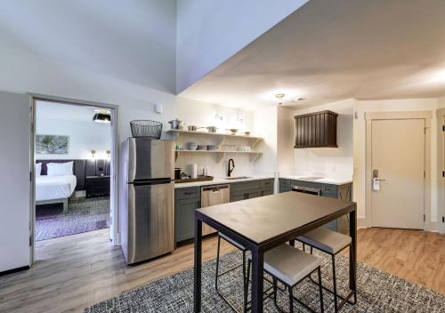 a kitchen with a table and a room with a bed at Sea Palms Resort St Simons Island in Saint Simons Island