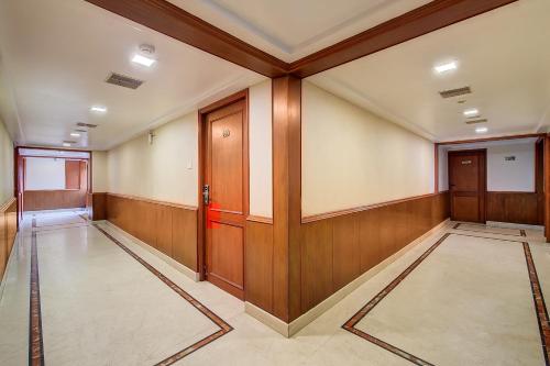 an empty room with wood paneled walls and doors at Metro Grand Hotel in Chennai