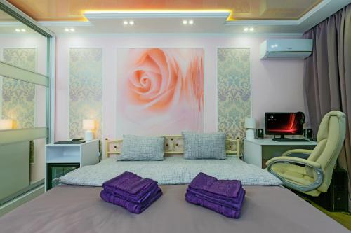 a bedroom with a bed with purple pillows on it at Hammam , big Jacuzzi ,Sauna , 2 bedroom , Khrechatik in Kyiv