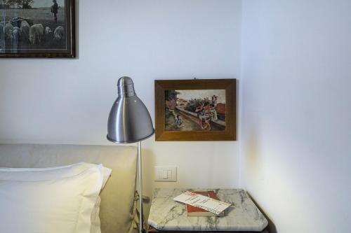 En eller flere senge i et værelse på Cozy Family Apartment in Castelletto