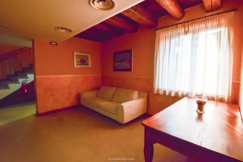 a living room with a couch and a window at Hotel Quo Vadis in Udine