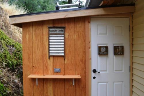 a shed with a door and a sign on it at The Quail's Nest in Three Rivers