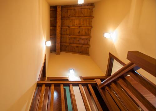 a set of stairs in a room with two lights at La Arcadia de Portillo in Portillo