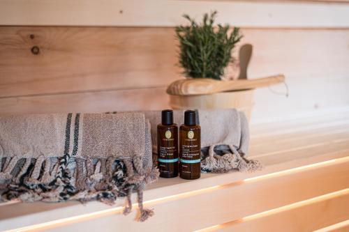 two bottles of essential oils sitting on a shelf at Der Jägersberg in Fischen