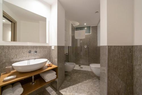 a bathroom with a sink and two toilets at Le Stanze del Lago Lake View in Como