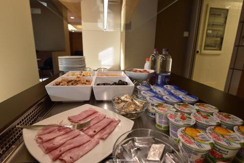 a counter with food on a counter top at Hotel Quo Vadis in Udine