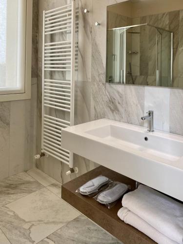 a bathroom with a sink and a mirror at Villa Pioppi Hotel in Sirmione