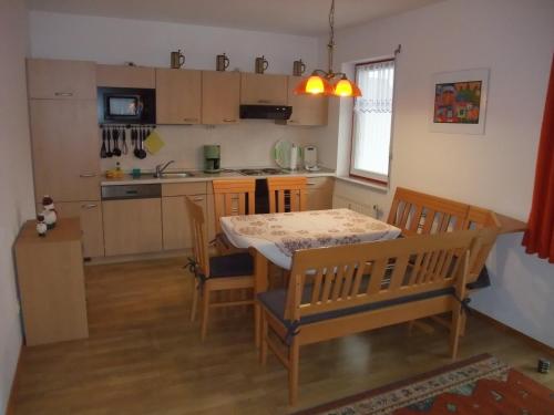 a kitchen with a table and chairs in a room at Ferienhaus Hubertus in Elend mit Balkons in Elend