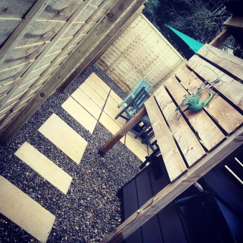 an overhead view of a wooden deck with a table and chairs at Aiskew Villa Annex in Bedale