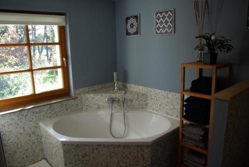 a bath tub in a bathroom with a window at Waldblick in Bleckede