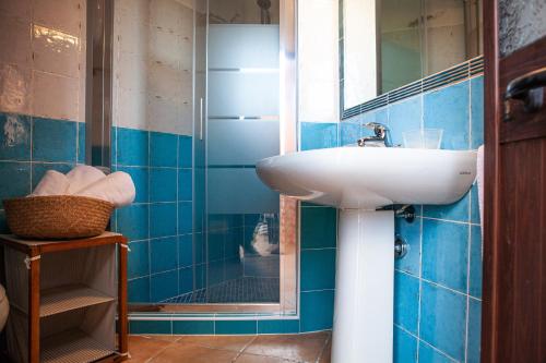 a bathroom with a sink and a mirror at DomoMea - Villetta Poseidone in Costa Rei