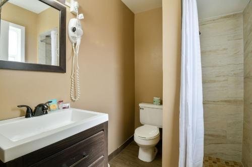 a bathroom with a sink and a toilet and a mirror at Inca Inn Moab in Moab