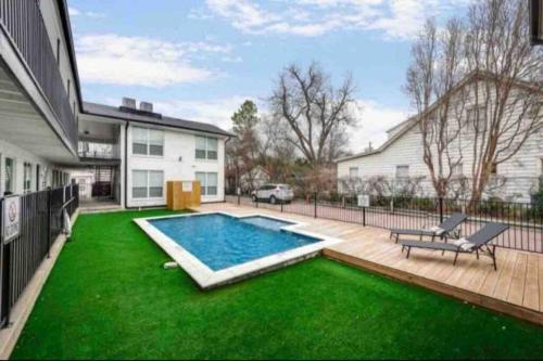a backyard with a swimming pool and green grass at Global Cup The Alcove Dallas Near Downtown Fun Nightlife in Dallas