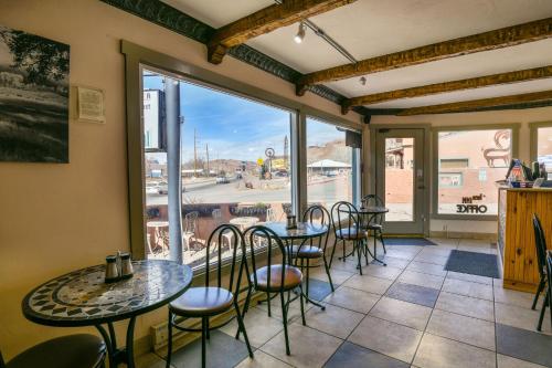 a room with tables and chairs and a large window at Inca Inn Moab in Moab