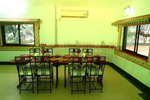 a dining room with a table and chairs at TOURIST VILLAGE KHAJURAHO in Khajurāho