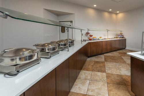 a kitchen with many pots and pans on a counter at Holiday Inn Hotel & Suites Memphis-Wolfchase Galleria by IHG in Memphis