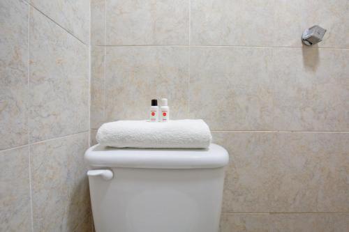 a white toilet with two candles on top of it at Hotel Villa Hermosa in Oaxaca City
