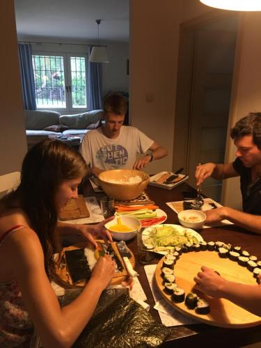 a group of people standing around a table with food at DOM 4 POKOJE Z BASENEM BLISKO WARSZAWY in Józefów
