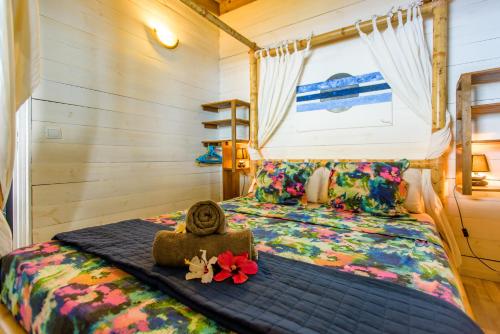 a bedroom with a bed with a blue comforter at Ré Océan in Saint-Leu